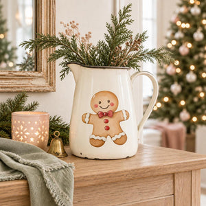 Gingerbread Bakery gingerbread boy transfer on a white enamel pitcher with holiday greenery.